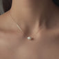 Dekolleté mit Halskette Hana in Roségold mit großer ovaler Perle 