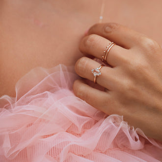 Hand mit Ring JOELLE in Roségold mit Edelstein Morganite und weißen Diamanten, und zarten Ringen in Roségold